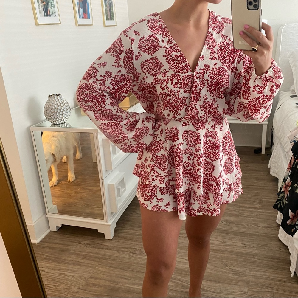 Red and white long sleeve paisley romper with ruffled bottom and tie back